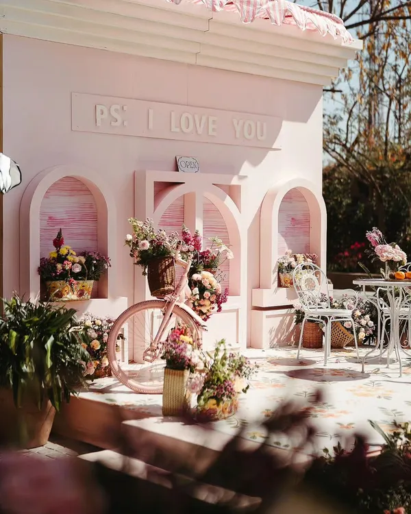 For a bride who loves street markets, I designed this 'Parisian Market' Mehendi. This 'PS I Love You' photo booth, complete with a flower-filled bicycle, became the perfect spot for romantic and whimsical pictures.