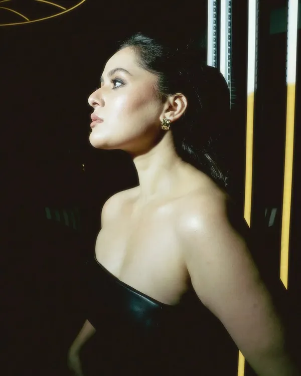 A dramatic, moody shot featuring a midnight smokey eye and a nude lip. This profile view highlights the glowing skin and the sharp contour, creating a high-fashion look.