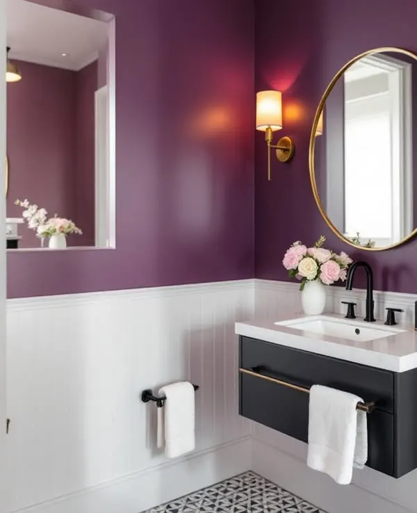 This powder room makes a bold statement with its rich purple walls and white wainscoting. The floating vanity, gold accents, and patterned floor tiles create a look of modern elegance.