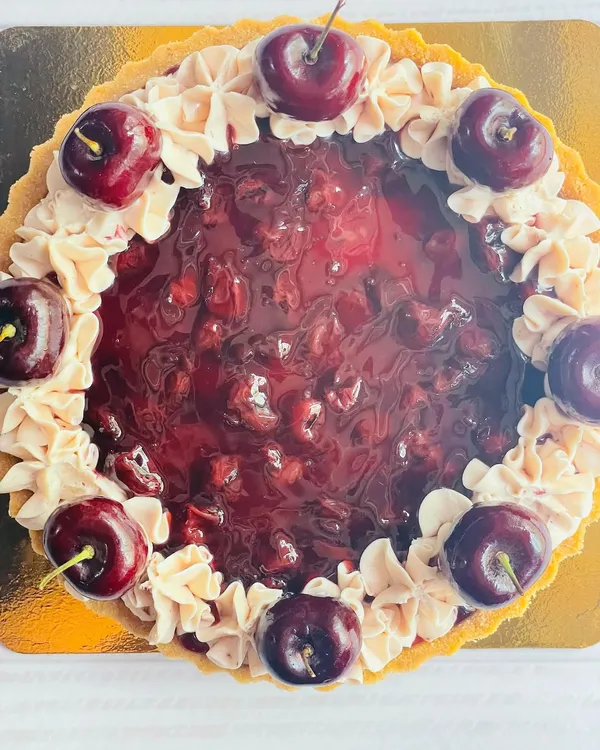 Experience the perfect harmony of flavors in my Cherry Cheesecake Tart. A buttery crust holds a creamy cheesecake filling, topped with a sweet cherry compote and fresh cherries.