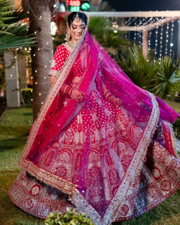 This stunning bride is glowing in one of our pre-loved bridal lehengas. We love the intricate silver embroidery on the vibrant pink fabric, perfect for making a grand entrance on your big day. You don't need to spend a fortune to get your dream wedding look.