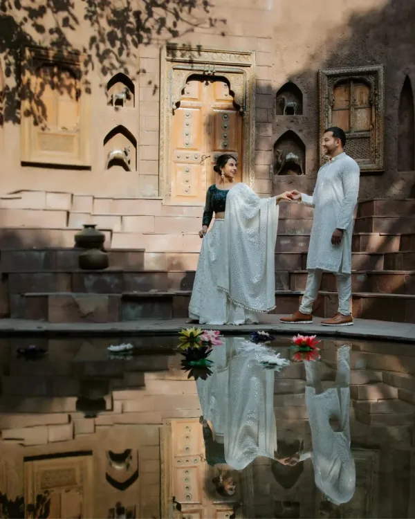 A timeless portrait at a heritage location, using the still water to create a perfect reflection. This shot combines royal architecture with a quiet, romantic moment, showcasing our signature style of blending grandeur with intimacy.