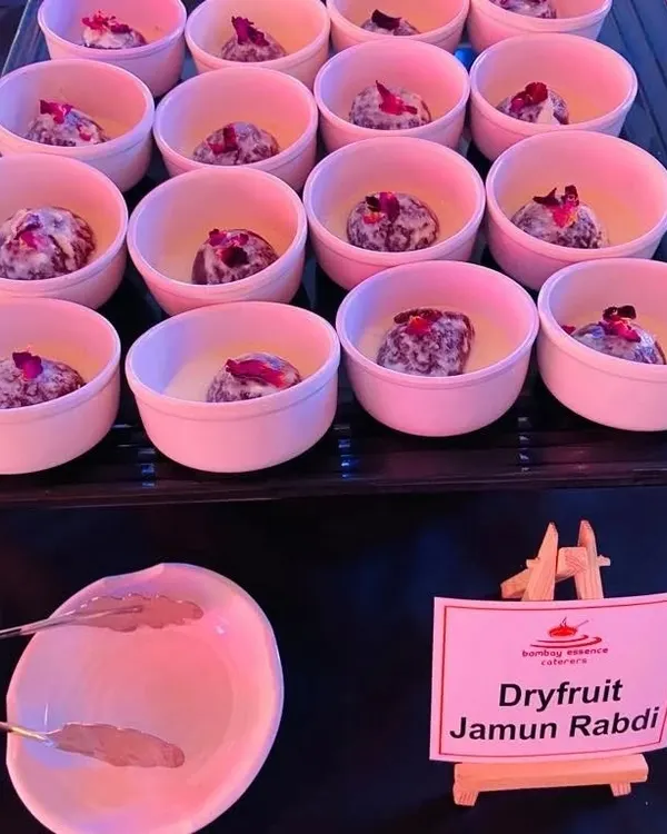 Our Dryfruit Jamun Rabdi is a rich and decadent dessert. Soft gulab jamuns are served in a creamy, thickened milk rabdi and garnished with dried rose petals for an elegant touch.
