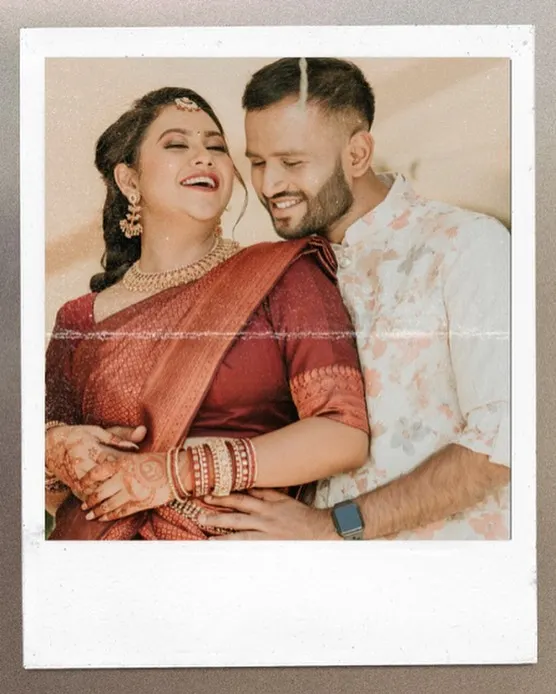 A candid, joyful moment between a couple, captured in a polaroid-style frame. The genuine laughter makes this a precious memory.