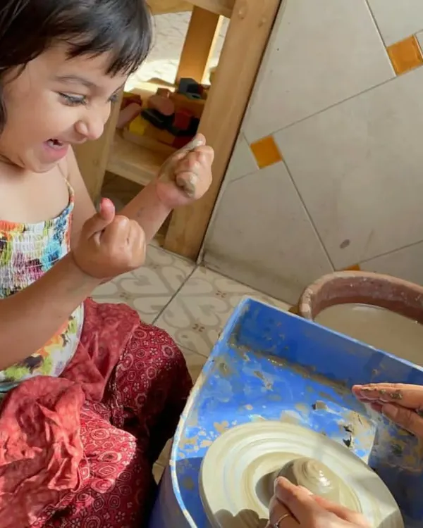 The look of pure excitement! There's nothing quite like the feeling of shaping clay on a spinning wheel. I guide them, but the creation is all theirs.