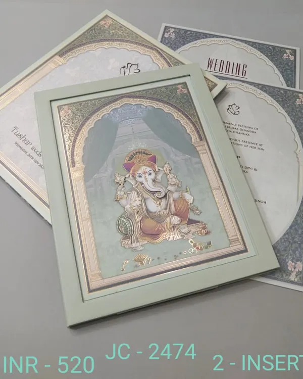 This premium invitation features a beautiful, framed illustration of Lord Ganesha, perfect for seeking blessings for your union. The card has a serene green color and includes two inserts.