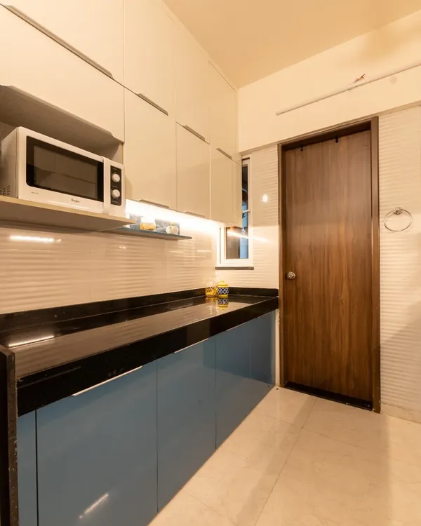 A look inside a Pune home we designed, showcasing the modular kitchen with its clean blue and white theme.
