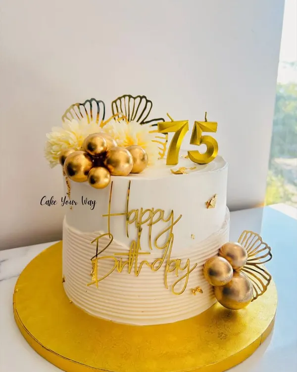 A golden celebration for 75 golden years. This elegant white and gold cake is perfect for a milestone birthday.