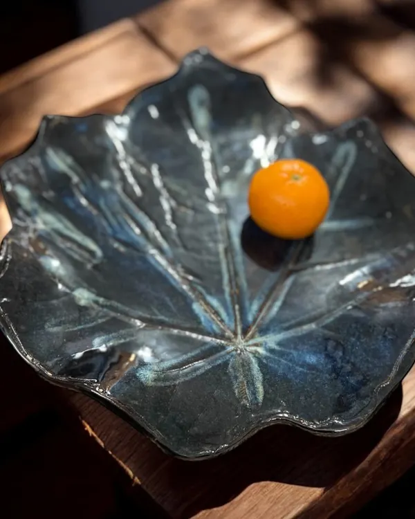 This large platter began as a fallen leaf I found on my travels. I was captivated by its grand scale and quiet presence, so I brought it back to my studio to translate its form into clay. It’s a piece that holds a memory, a perfect example of how I find inspiration in the world around me for my artisan ceramic home decor.