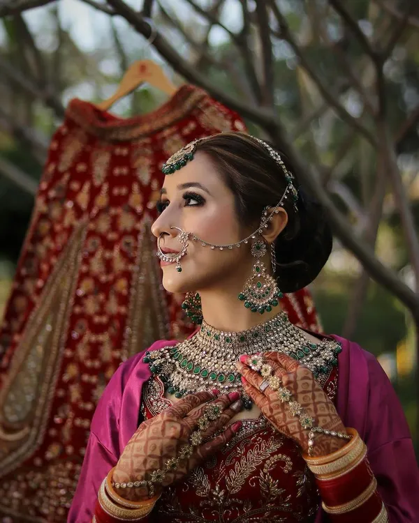 A breathtaking bridal look featuring intricate jewelry, a classic updo, and flawless makeup. The focus is on creating a timeless and elegant style for the big day.