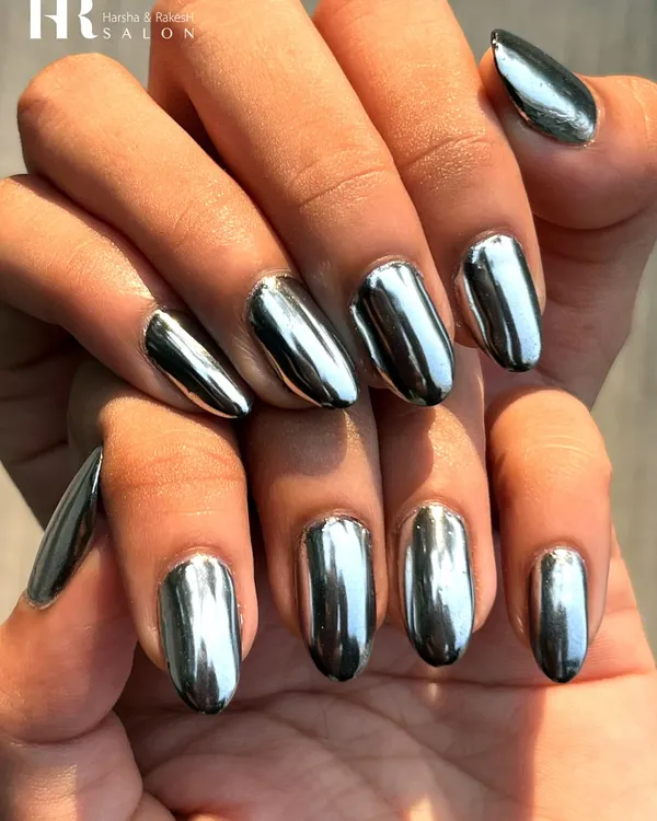 A flawless, mirror-like finish that captures the light from every angle. We achieved this liquid metal look using high-quality silver chrome powder over perfectly shaped almond nail extensions for a bold, futuristic, and utterly glamorous statement.