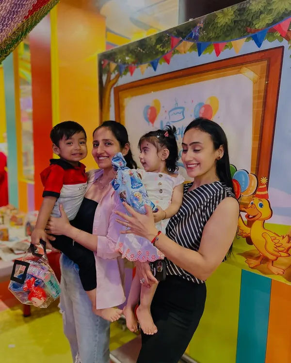 Mothers and toddlers pose together during a birthday celebration, capturing the happy, communal spirit of our club.