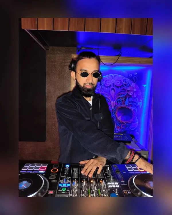 In my element, focused on the mix. I use a Pioneer DJ controller, the industry standard for professional club DJs.