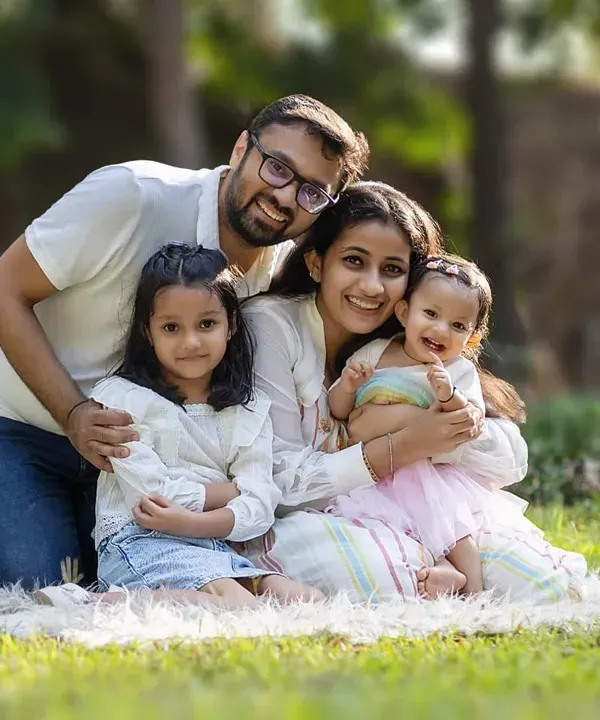 A picture-perfect moment of family joy. This outdoor session in a beautiful park setting captures the warmth and happiness of this family of four.