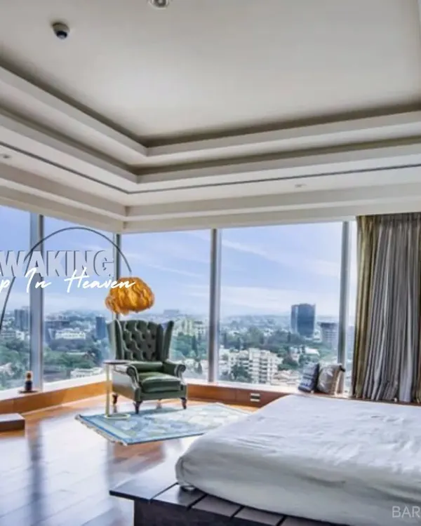 This is what waking up in heaven looks like. We designed this luxury bedroom to maximize the stunning city views, creating a serene escape with a sophisticated, modern feel.