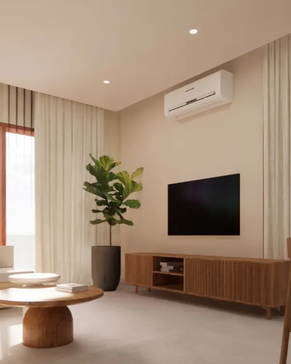 This living room from a Japandi-style villa uses a clean layout with a simple wooden media unit and a large fiddle-leaf fig plant to add life. The design prioritizes minimalism and natural light to create a peaceful and inviting atmosphere.