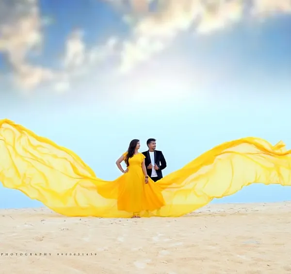 This is what dream photoshoots are made of. I offer complete packages that include stunning flying gowns like this yellow one, perfect for a beach pre-wedding shoot in places like Mangalore or Udupi.