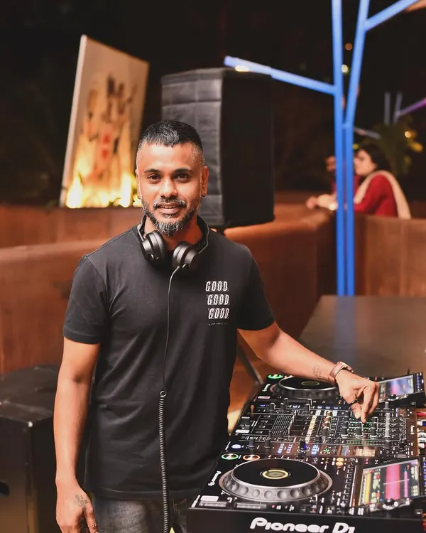 A portrait of me at my workstation. This is where the magic happens, where I prepare my sets and manage the flow of the night.