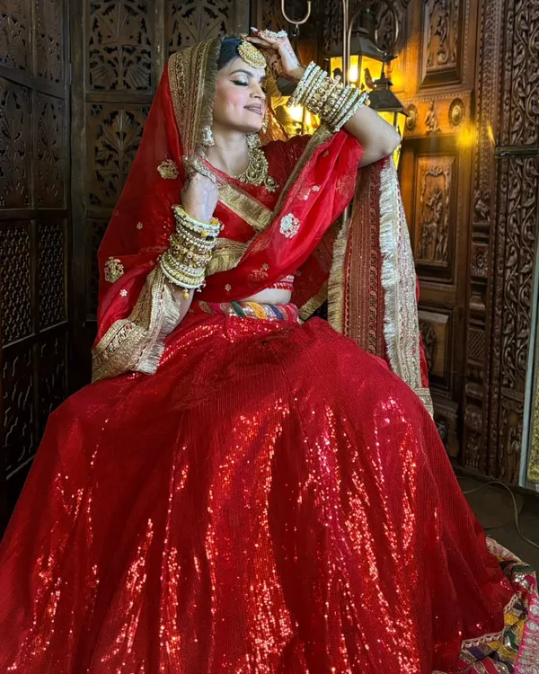 This is my absolute showstopper, a classic red sequin bridal lehenga that is guaranteed to make you the star of your wedding. It’s heavy, glamorous, and everything a bride dreams of.