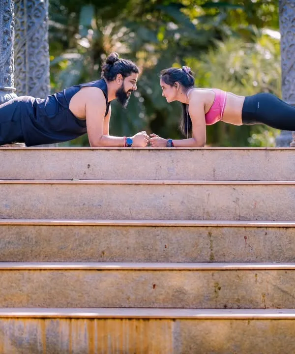 A couple that planks together, stays together. This fun fitness-themed shot on a set of stairs shows off the couple's strength and teamwork.