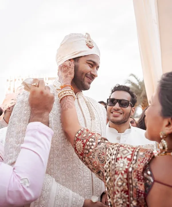 A mother's loving touch as she blesses her son on his wedding day. It's these candid, emotional interactions with family that form the heart of a wedding story.