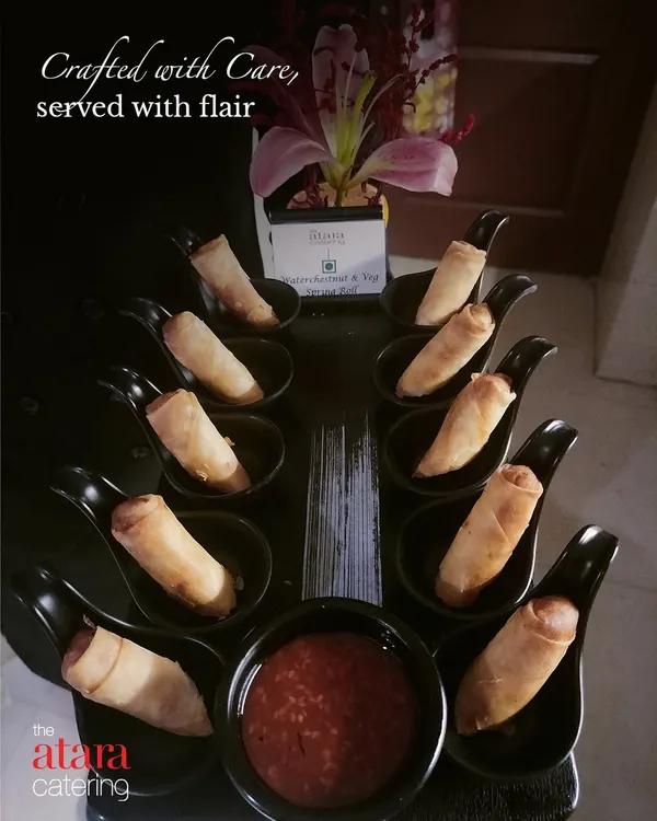 Crafted with care, served with flair. This image of elegantly presented spring rolls shows our attention to detail from the kitchen to the final presentation on your table.