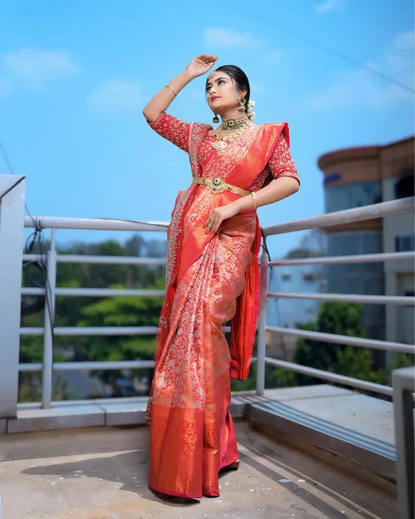 This is the classic South Indian muhurtham bridal look I love to create. I focus on draping heavy silk sarees to create a majestic yet comfortable feel, ensuring the pleats are perfect and the traditional oddiyanam belt sits beautifully.
