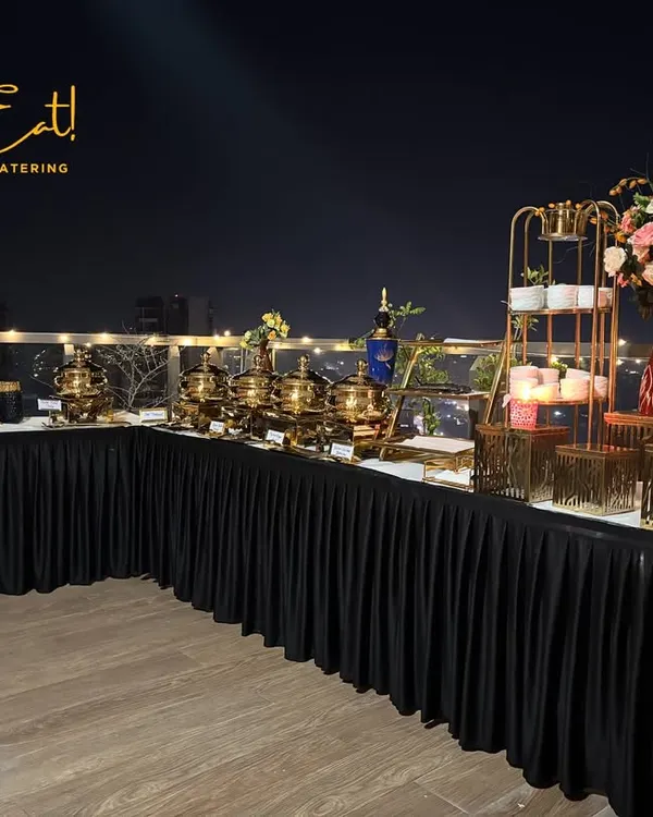 A stunning rooftop party setup against the city skyline. We specialize in creating these elegant, premium buffet experiences for any occasion, complete with ambient lighting and sophisticated decor.
