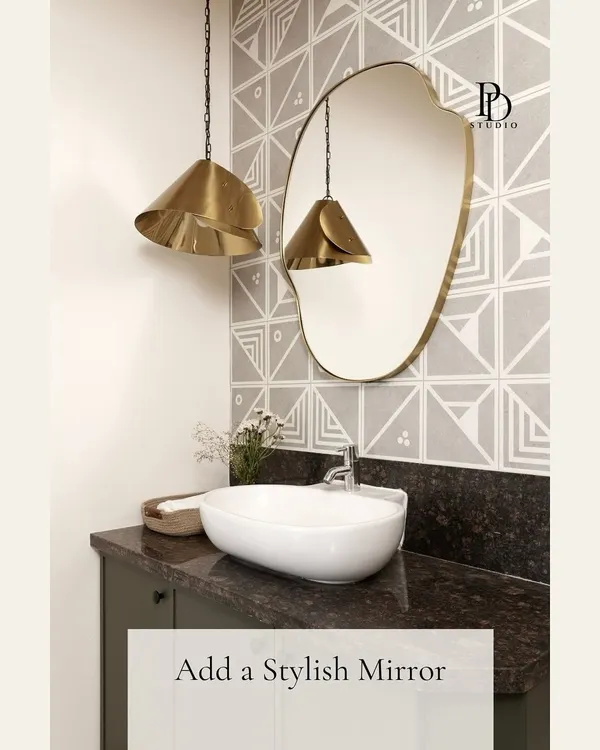 A stylish, organically shaped mirror can instantly become the focal point of a bathroom. Here, it's paired with geometric wallpaper and brass pendant lights to create a powder room with significant personality.