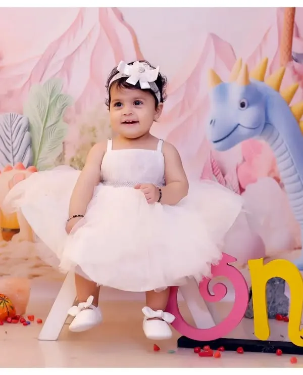 A beautiful portrait from our dinosaur-themed shoot. This setup uses a pastel color palette for a softer, more whimsical take on the theme, perfect for a first birthday.