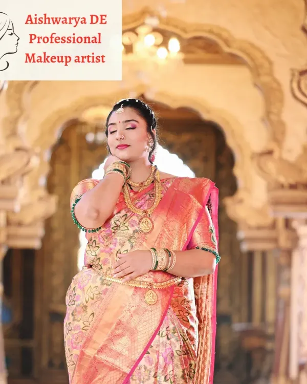 A beautiful portrait of a South Indian bride, showcasing the harmony between the makeup and the rich tissue silk saree. The look is completed with layered gold necklaces and a traditional waist belt.
