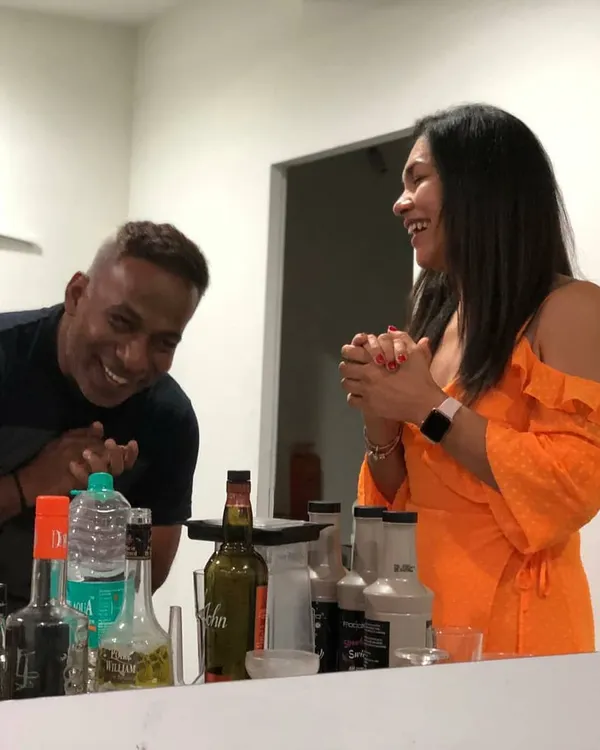Sharing a laugh with a guest during a fun and interactive cocktail making session at a house party. These moments of joy and connection are what it's all about.