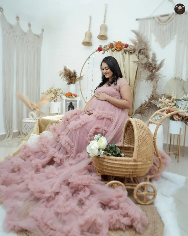 This boho-chic setup in my Hubli studio is one of my most requested styles. The flowing pink gown, wicker baby pram, and natural elements like pampas grass create a warm, dreamy, and picture-perfect setting to celebrate your pregnancy.