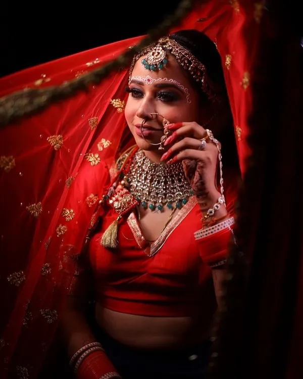 A stunning portrait of my Bengali bride. The traditional 'chandan' design on her forehead is beautifully complemented by the bold, defined eyes and red saree.
