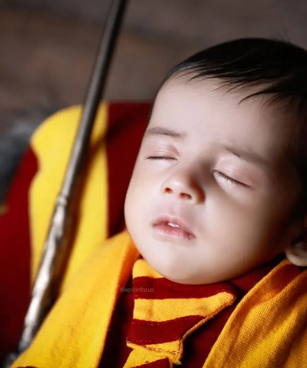 A close-up of our Harry Potter theme, showing the baby peacefully sleeping with a wand. We pay close attention to every detail to make our creative themes authentic and magical.