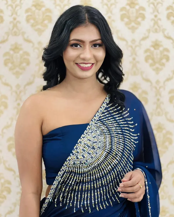 A touch of glam for a special evening out. This look features defined eyes with winged liner, softly contoured cheeks, and a beautiful berry lip color that complements her royal blue saree.