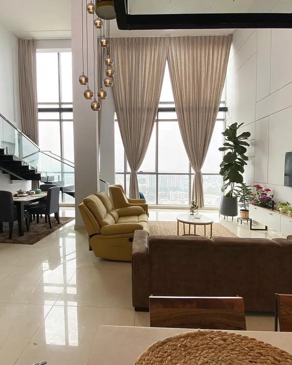 This breathtaking double-height living space in a penthouse project showcases how I use natural light, grand scale, and minimalist design to create an atmosphere of understated luxury and elegance.