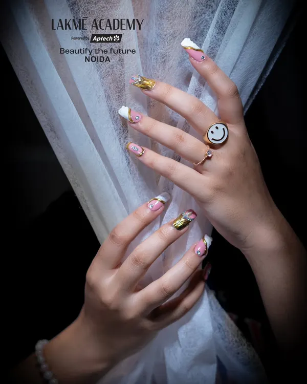A perfect example of the elegant nail art popular in our courses, featuring a mix of white, pink, and gold chrome accents. Students learn to combine different finishes for a dynamic and stylish result.