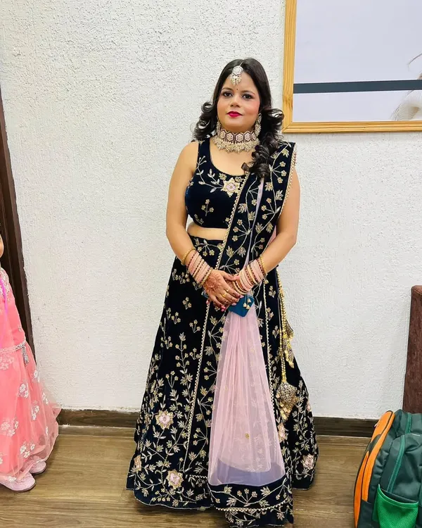 A full look at a client ready for a party or wedding, with professional makeup and curled hair styling.