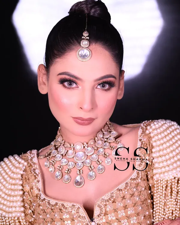 This is the kind of flawless, high-definition bridal makeup I teach in my professional courses. Notice the clean, sharp eye makeup, the perfectly blended skin, and the elegant updo that completes the look.