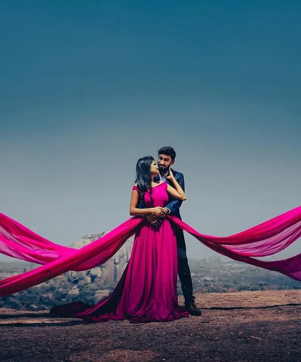 This stunning magenta trail gown is a favorite for pre-wedding photoshoots. The flowing fabric creates incredible, dramatic shots against any backdrop, ensuring your photos are unforgettable.