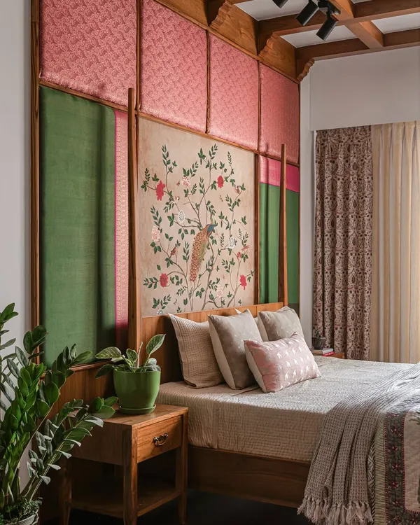 This bedroom, from "The Varnam Edit," features a queen-sized bed with a custom headboard made of silk, brocade, and a hand-painted central panel. The design brings heritage and quiet power into the room.