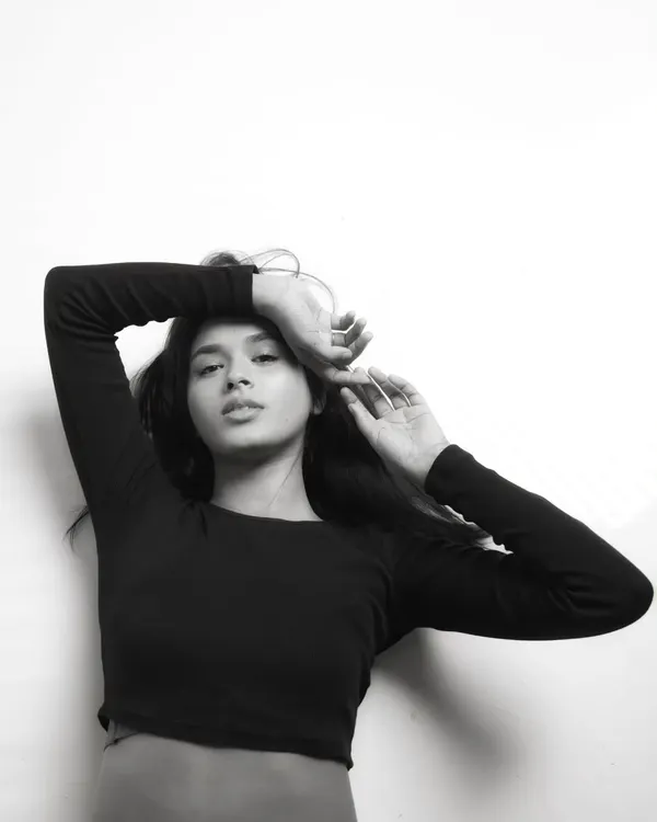 A beautiful black and white conversion of a studio portrait. The lack of color emphasizes the model's expression and the soft, natural light.