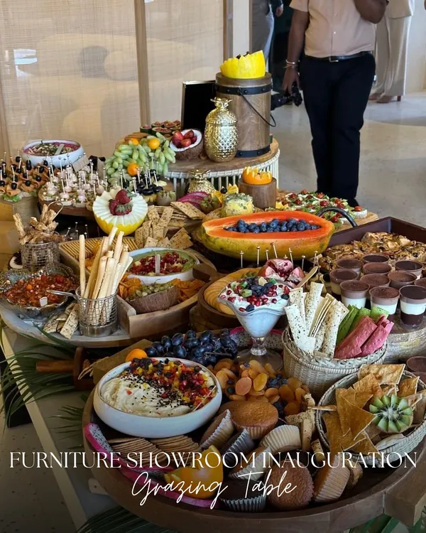 This is what we mean by a feast for the eyes. Our artisanal grazing tables, like this one for a furniture showroom inauguration, are designed to be stunning centerpieces, overflowing with a variety of cheeses, fresh fruits, charcuterie, and handcrafted bites.