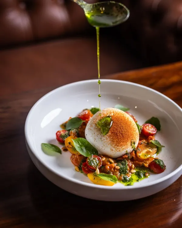 A perfect meal can start with something fresh and vibrant. My Burrata salad features a creamy center that spills onto a bed of sweet cherry tomatoes and basil pesto. A final drizzle of extra virgin olive oil makes it simple, elegant, and incredibly delicious.