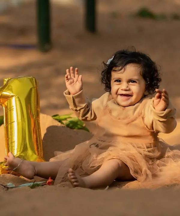 Celebrating one year of life with an outdoor session. This little one was so happy to play in the sand, and the simple '1' balloon marks the occasion perfectly while letting her personality be the main focus.