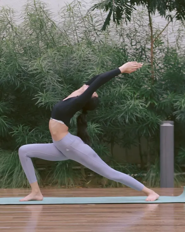 This is a variation of Veerabhadrasana, the Warrior Pose. It's a powerful asana that builds strength in the legs and core while opening the chest and shoulders. It’s a perfect example of how we combine stretching with strengthening.