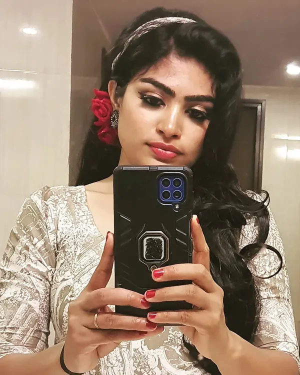 A fun retro-inspired look for an office event. I created dramatic winged eyeliner and paired it with a bold red flower for that classic old-Bollywood glamour.