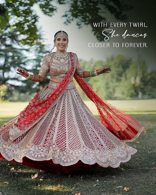 With every twirl, she dances closer to forever. This bride radiates joy in her traditional red Tarun Tahiliani lehenga, a look we curated to be both classic and full of life.
