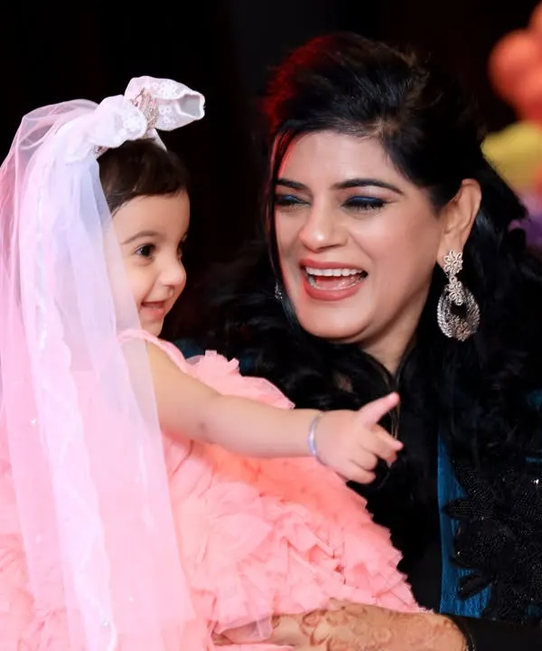 A beautiful candid moment between a mother and her daughter during a Disney-themed birthday party. These natural interactions are the heart of family function photography.